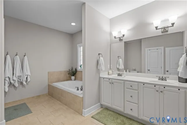 a white bath tub sitting in a bathroom next to a window