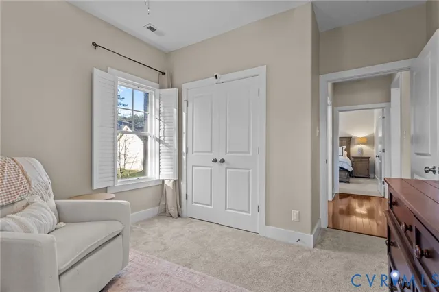 a bedroom with a bed dresser and a window