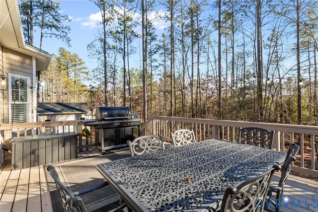 a view of a yard with large trees and wooden fence