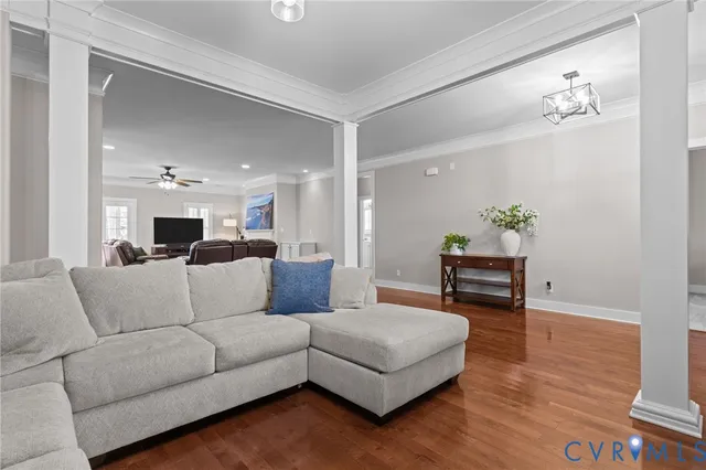 a living room with furniture and a dining table with kitchen view