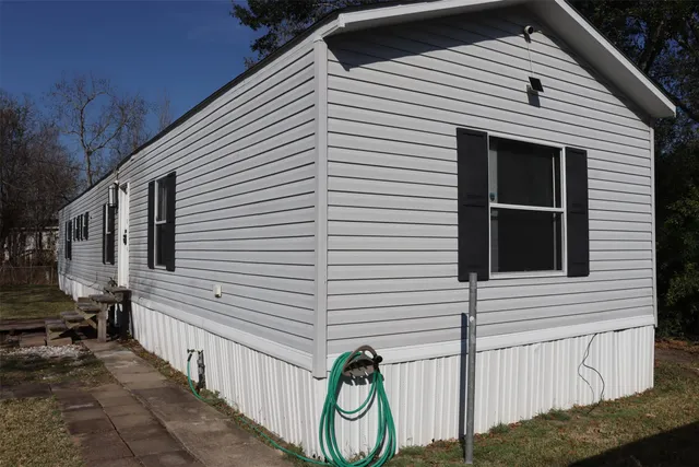 a view of a house with a small yard
