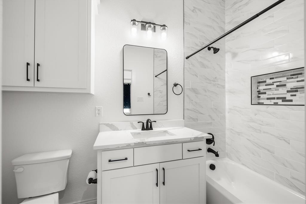 1868 Meadowview Canton, TX 75103 - Photo 28 of 40 a bathroom with a sink a vanity and a mirror