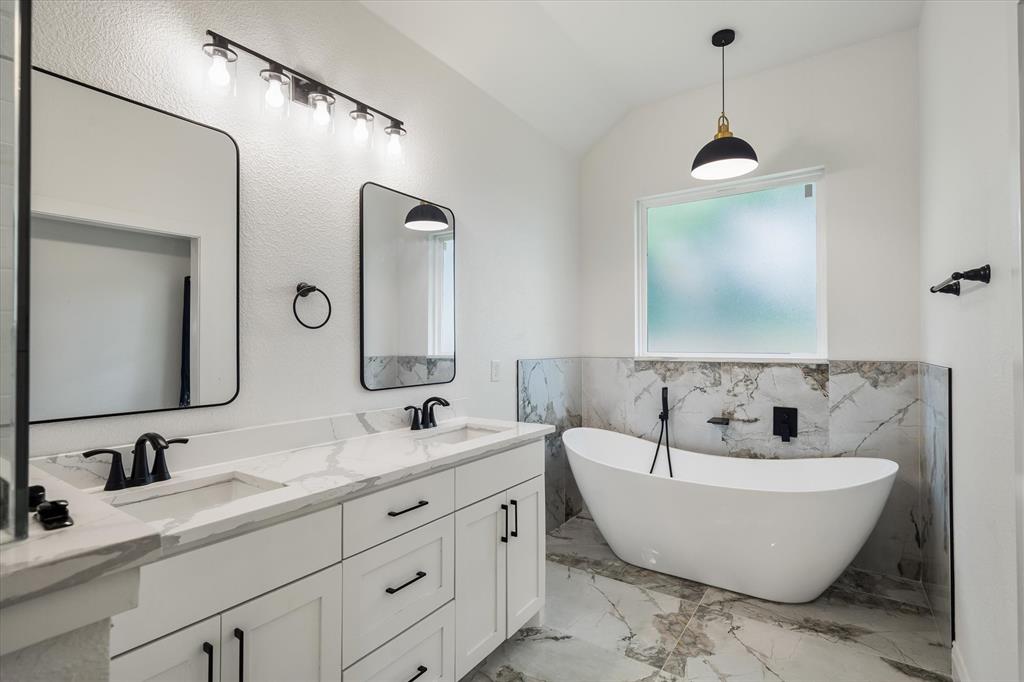 1868 Meadowview Canton, TX 75103 - Photo 32 of 40 a bathroom with a double vanity sink mirror and bathtub