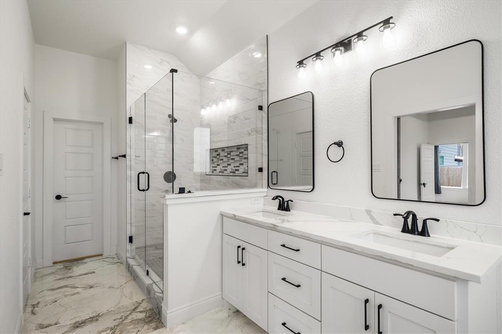 1868 Meadowview Canton, TX 75103 - Photo 33 of 40 a bathroom with a double vanity sink mirror and shower
