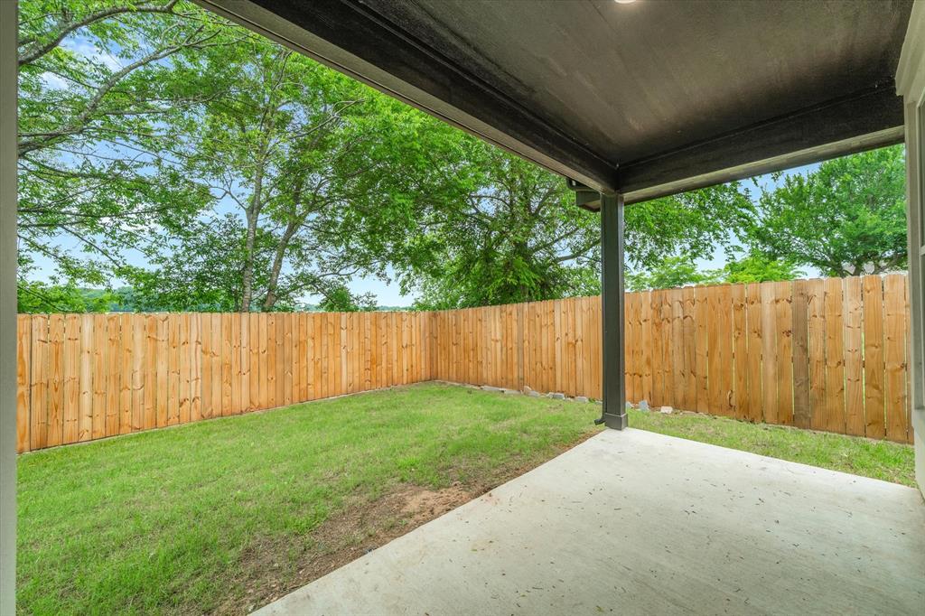 1868 Meadowview Canton, TX 75103 - Photo 38 of 40 a view of a backyard with large trees and wooden fence