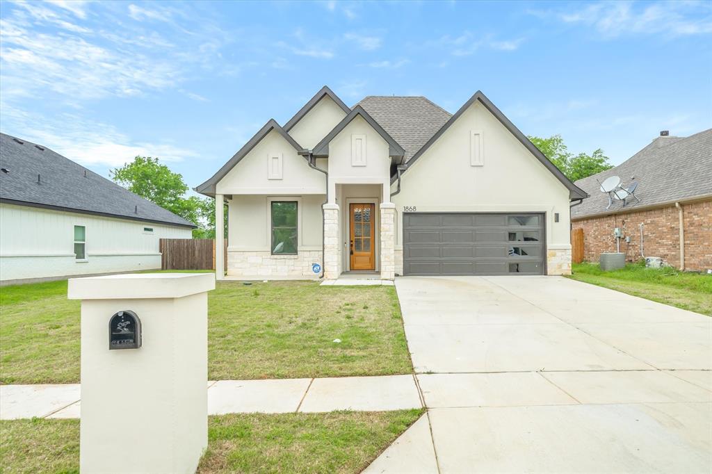 1868 Meadowview Canton, TX 75103 - Photo 8 of 40 a view of a house with a yard and garage