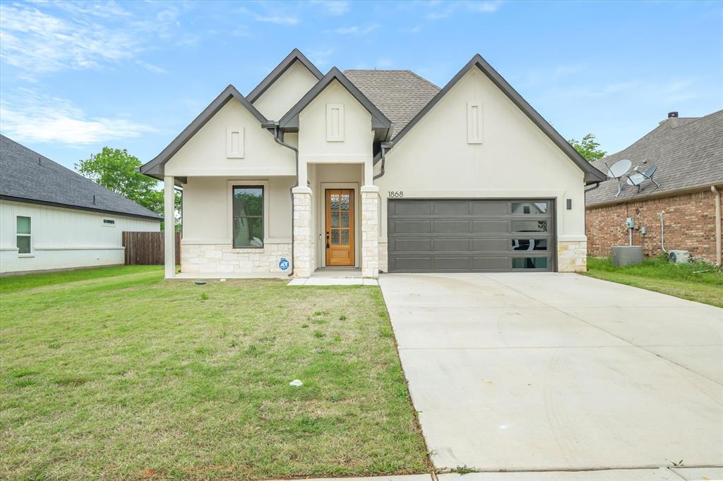1868 Meadowview Canton, TX 75103 - Photo 10 of 40 a front view of a house with a yard and garage