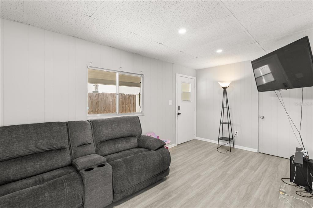 609 East Highland Street Altamonte Springs, FL 32701 - Photo 12 of 35 a living room with furniture and a flat screen tv