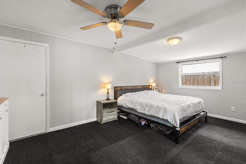 609 East Highland Street Altamonte Springs, FL 32701 - Photo 15 of 35 a bed sitting in a bedroom next to a window
