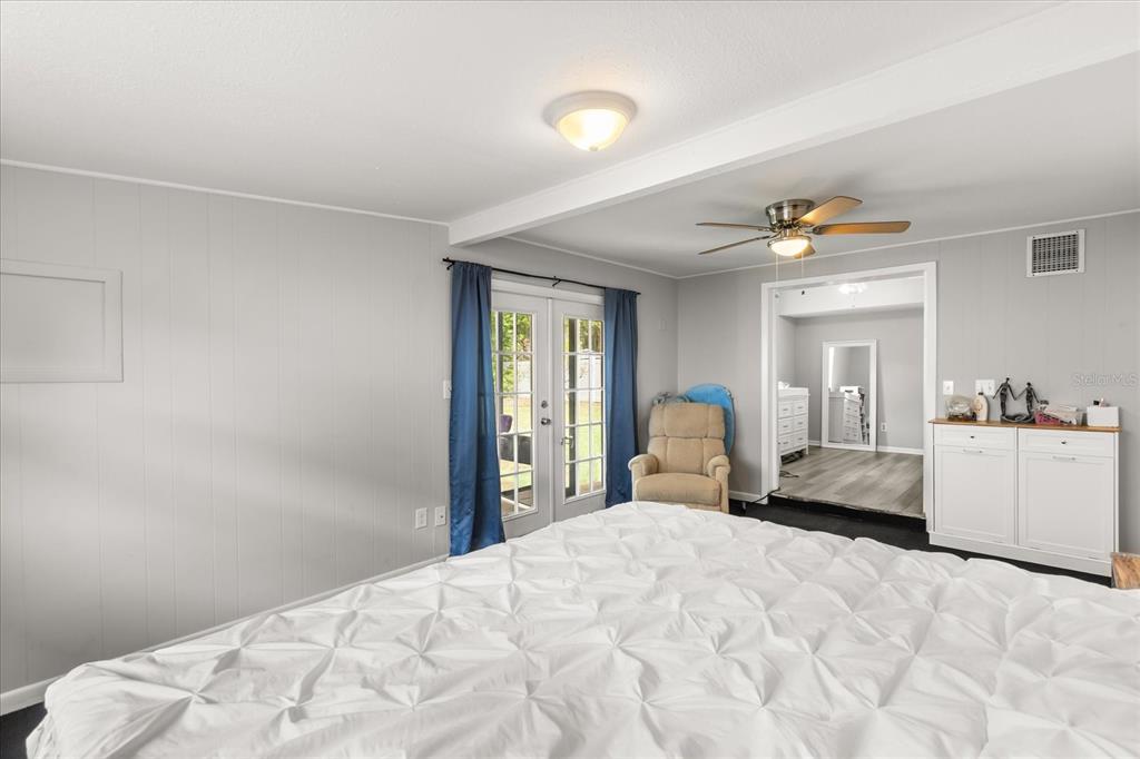 609 East Highland Street Altamonte Springs, FL 32701 - Photo 16 of 35 a bedroom with a bed and a chandelier