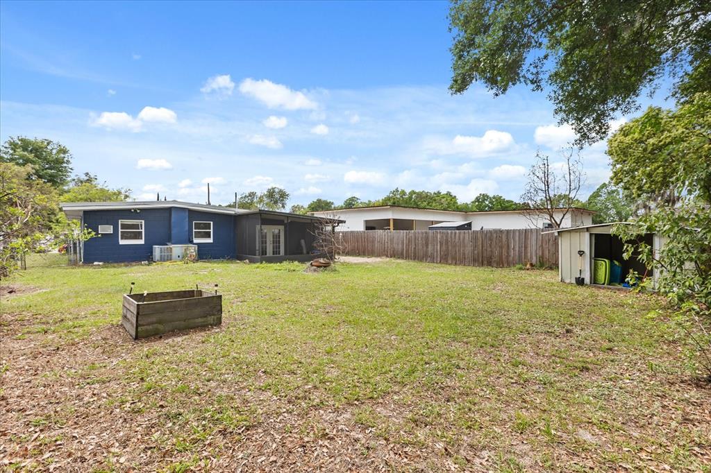 609 East Highland Street Altamonte Springs, FL 32701 - Photo 28 of 35 a swimming pool with some trees in the background