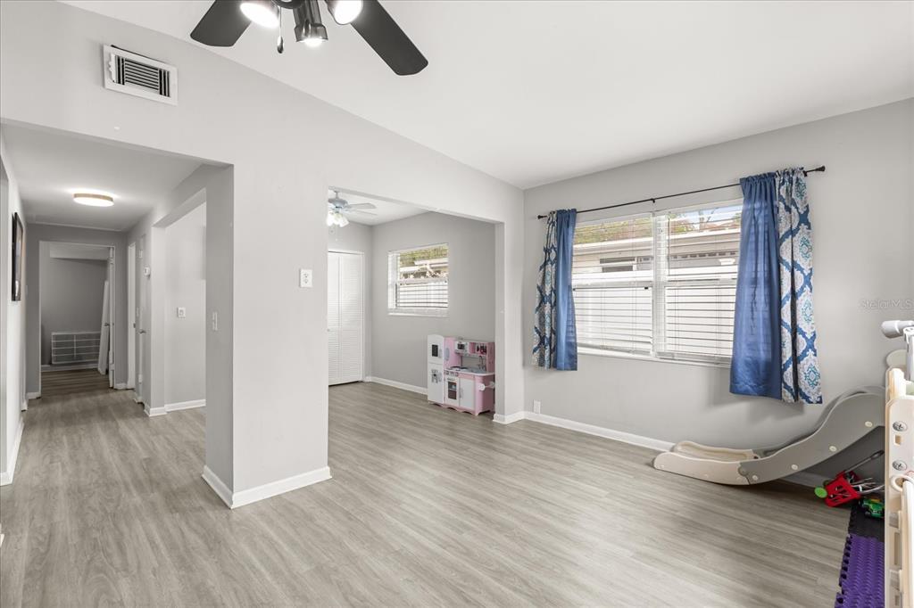 609 East Highland Street Altamonte Springs, FL 32701 - Photo 6 of 35 a view of an empty room with a window and wooden floor