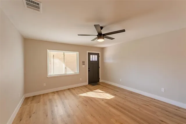 wooden floor in an empty room with a window