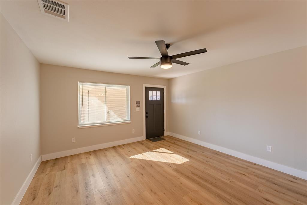 4306 Shallowbrook Trail, Unit A Austin, TX 78744 - Photo 3 of 16 wooden floor in an empty room with a window