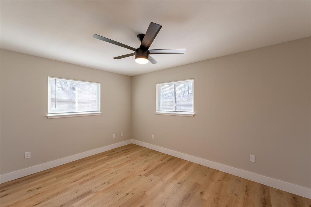 4306 Shallowbrook Trail, Unit A Austin, TX 78744 - Photo 8 of 16 a view of a big room with wooden floor and windows