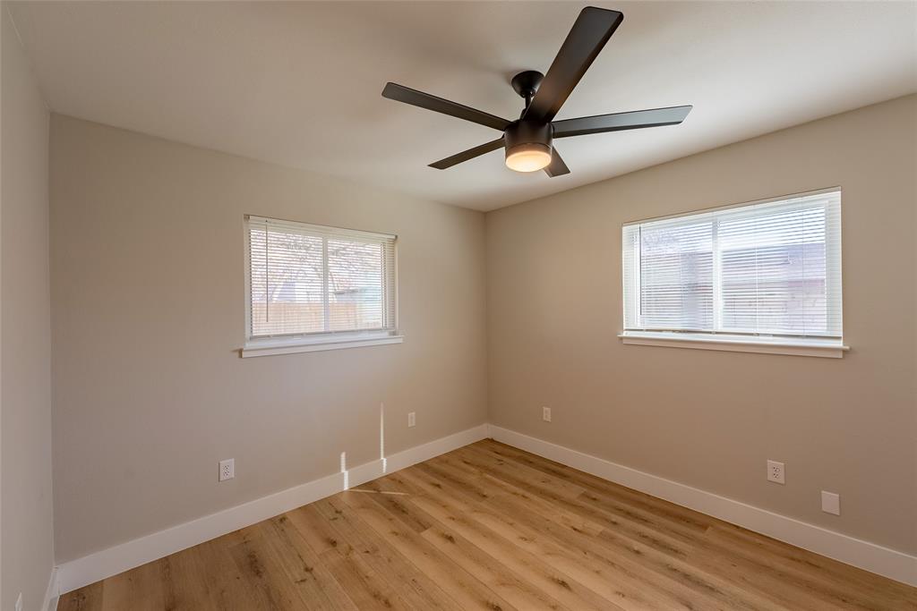 4306 Shallowbrook Trail, Unit A Austin, TX 78744 - Photo 10 of 16 a view of empty room with wooden floor and fan