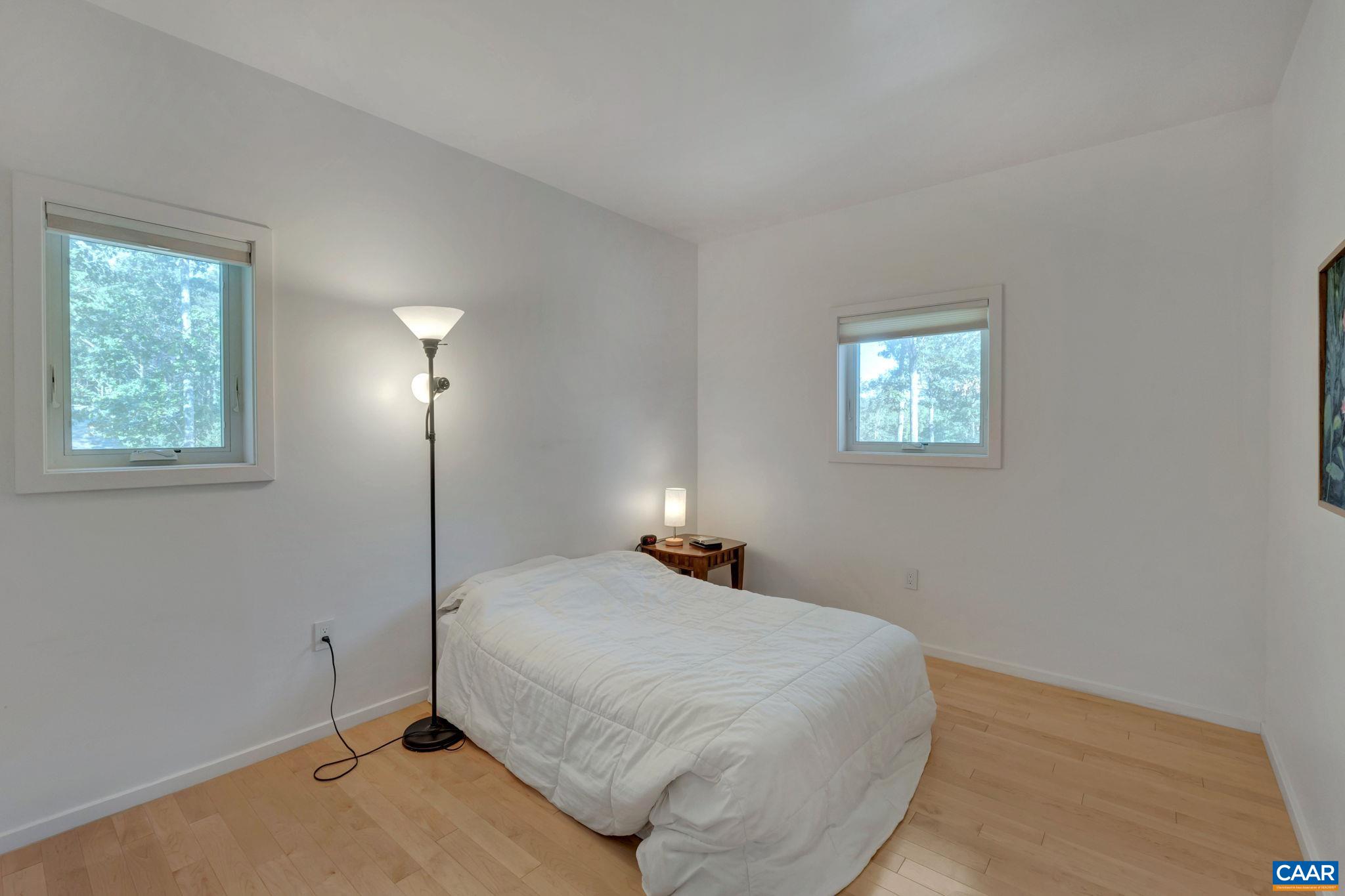 422 Unity Place Buckingham, VA 23921 - Photo 50 of 69 a bedroom with a bed and a lamp