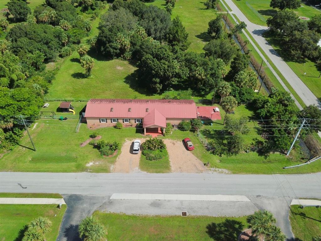704 Southwest 6th Street Okeechobee, FL 34974 - Photo 1 of 21 an aerial view of a house with a yard and garden