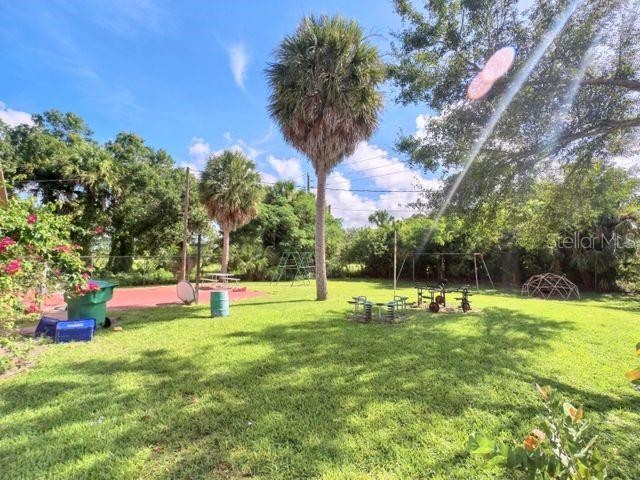 704 Southwest 6th Street Okeechobee, FL 34974 - Photo 12 of 21 a view of a playground with basketball court