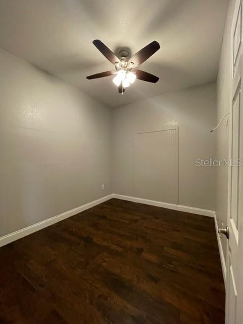 704 Southwest 6th Street Okeechobee, FL 34974 - Photo 15 of 21 an empty room with wooden floor and fan