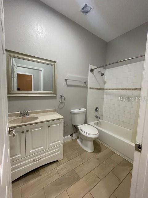 704 Southwest 6th Street Okeechobee, FL 34974 - Photo 19 of 21 a bathroom with a toilet a sink and bathtub