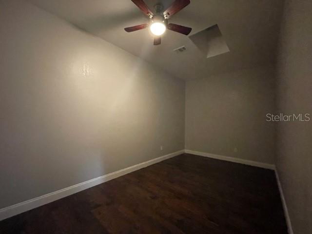 704 Southwest 6th Street Okeechobee, FL 34974 - Photo 20 of 21 en empty room with wooden floor and fan