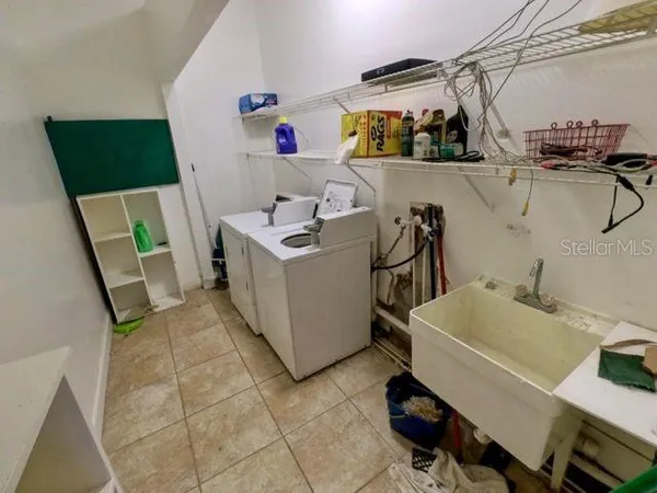 a view of storage and utility room with two washing machine