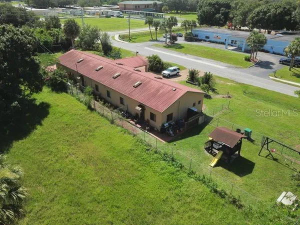 an aerial view of a house with yard swimming pool and outdoor seating