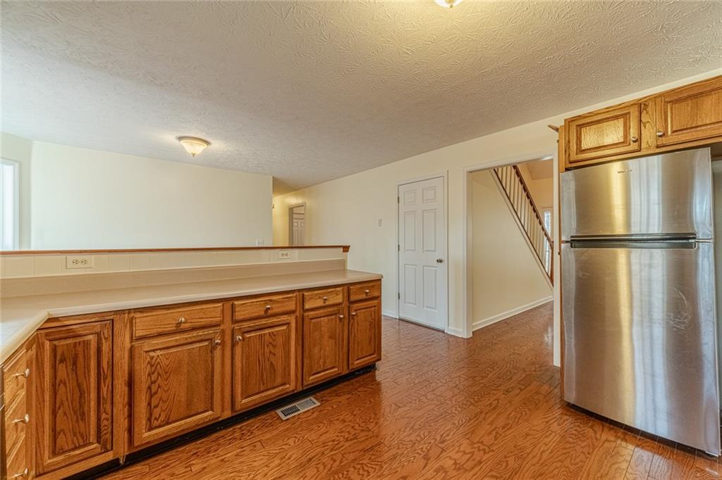 3240 Stewart Lake Road Monroe, GA 30655 - Photo 13 of 68 a view of a kitchen with wooden floor