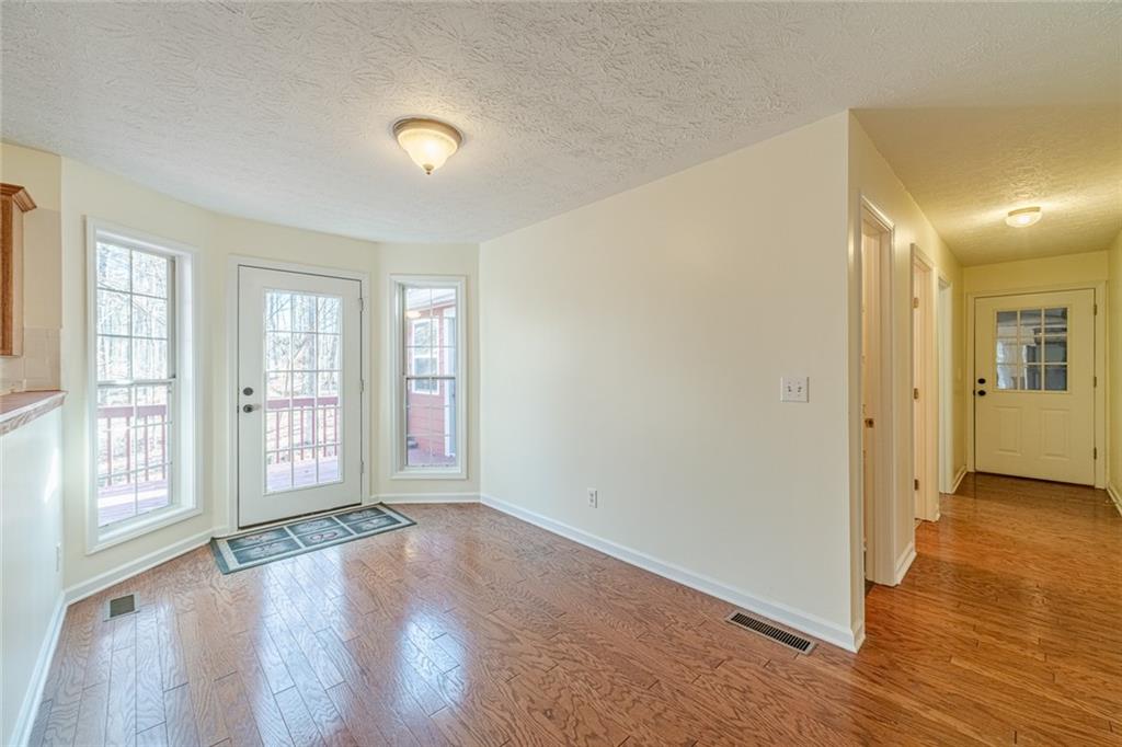 3240 Stewart Lake Road Monroe, GA 30655 - Photo 18 of 68 wooden floor in an empty room with a window