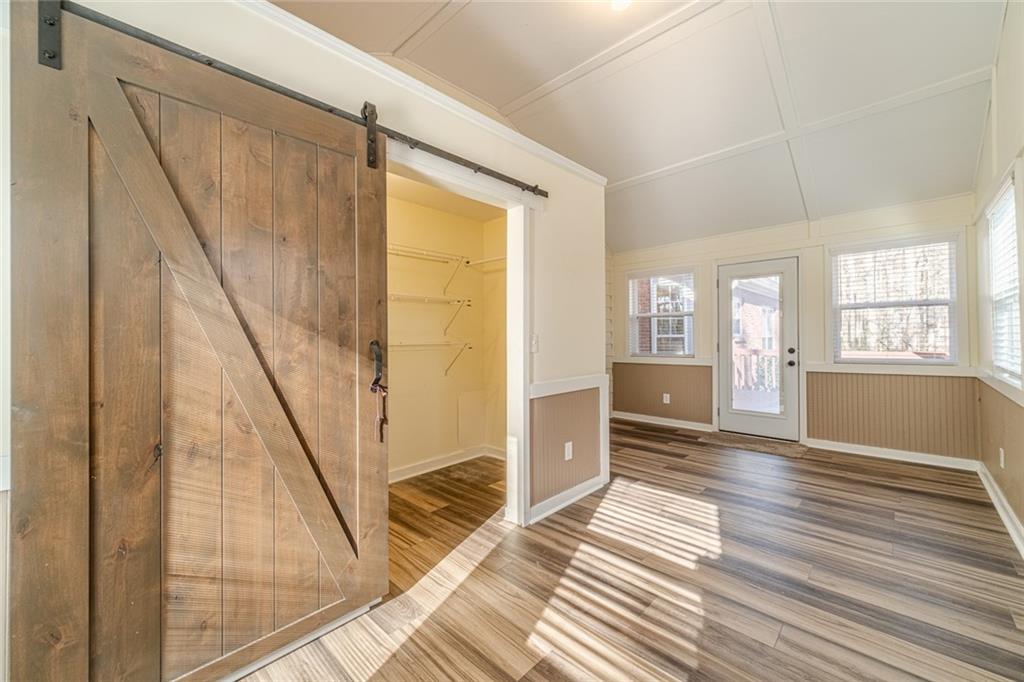 3240 Stewart Lake Road Monroe, GA 30655 - Photo 24 of 68 a view of an empty room with wooden floor and a window