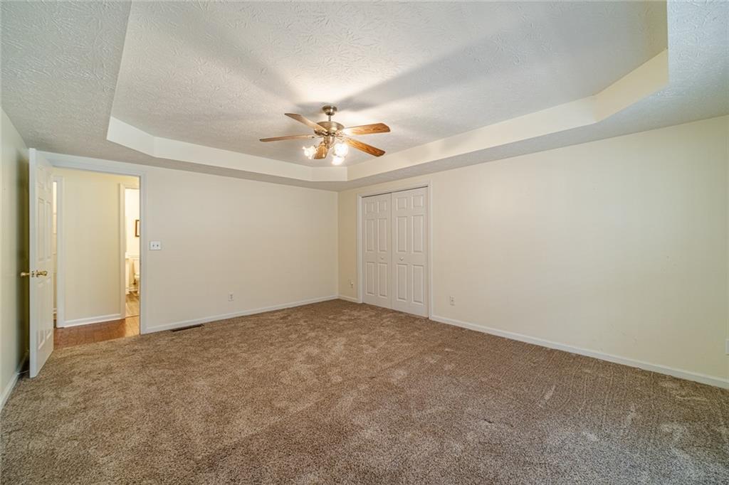 3240 Stewart Lake Road Monroe, GA 30655 - Photo 27 of 68 an empty room with a empty space and a ceiling fan