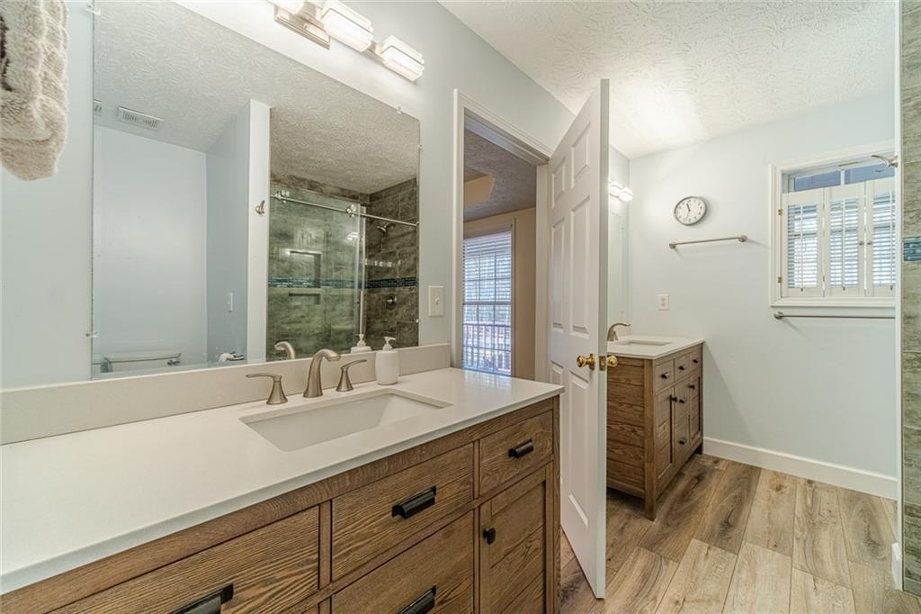 3240 Stewart Lake Road Monroe, GA 30655 - Photo 29 of 68 a bathroom with a sink double vanity and a mirror