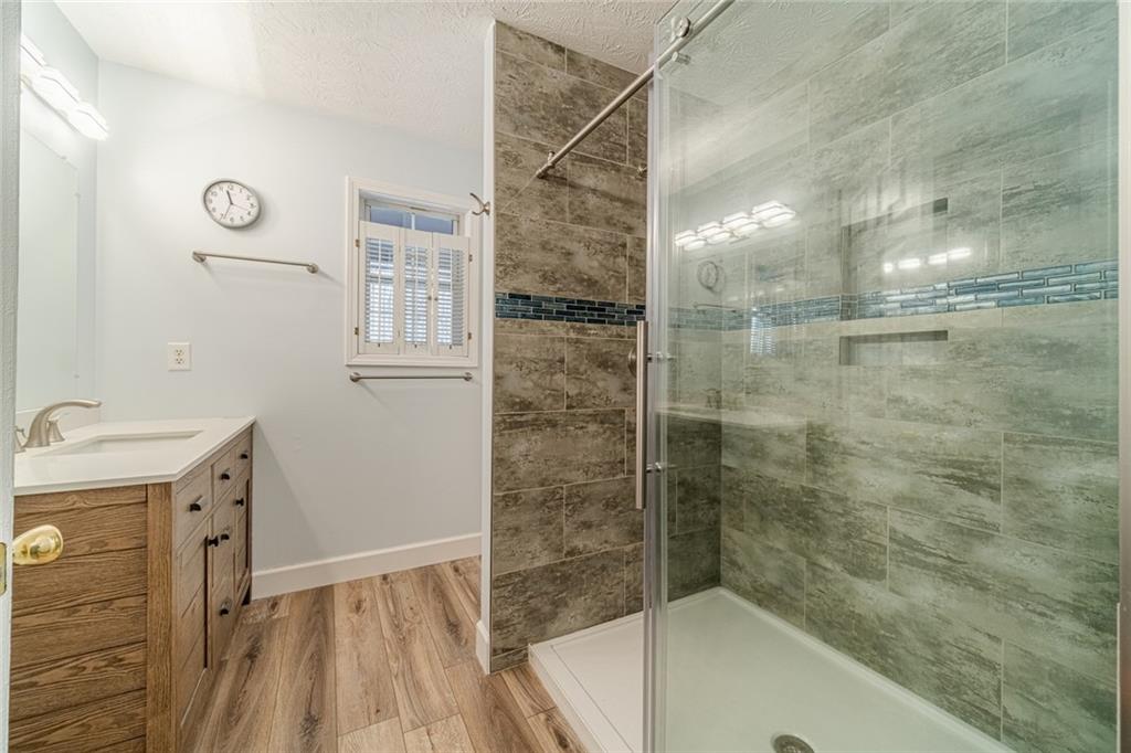 3240 Stewart Lake Road Monroe, GA 30655 - Photo 30 of 68 a bathroom with a bathtub and a sink