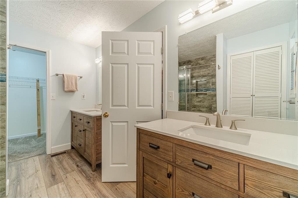 3240 Stewart Lake Road Monroe, GA 30655 - Photo 31 of 68 a bathroom with a sink double vanity and a mirror