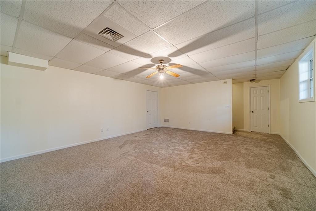 3240 Stewart Lake Road Monroe, GA 30655 - Photo 44 of 68 an empty room with a ceiling fan and a window