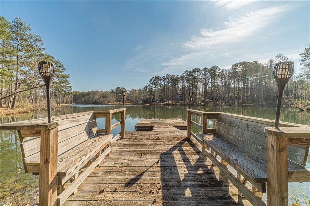 3240 Stewart Lake Road Monroe, GA 30655 - Photo 61 of 68 a view of a balcony with wooden floor and lake view