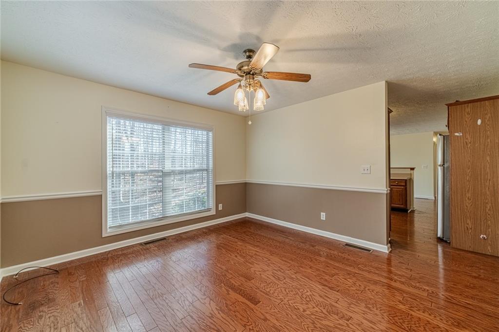 3240 Stewart Lake Road Monroe, GA 30655 - Photo 10 of 68 wooden floor in an empty room with a window