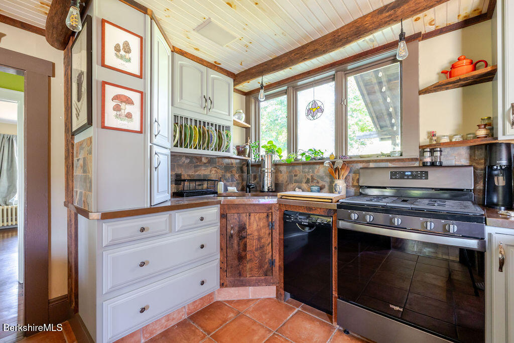 6 Locust Street Great Barrington, MA 01230 - Photo 11 of 36 a kitchen with stainless steel appliances granite countertop a stove and a microwave