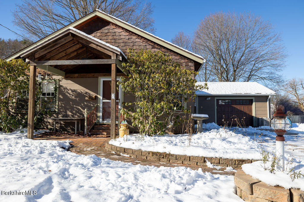 6 Locust Street Great Barrington, MA 01230 - Photo 2 of 36 a front view of a house with a yard covered in snow