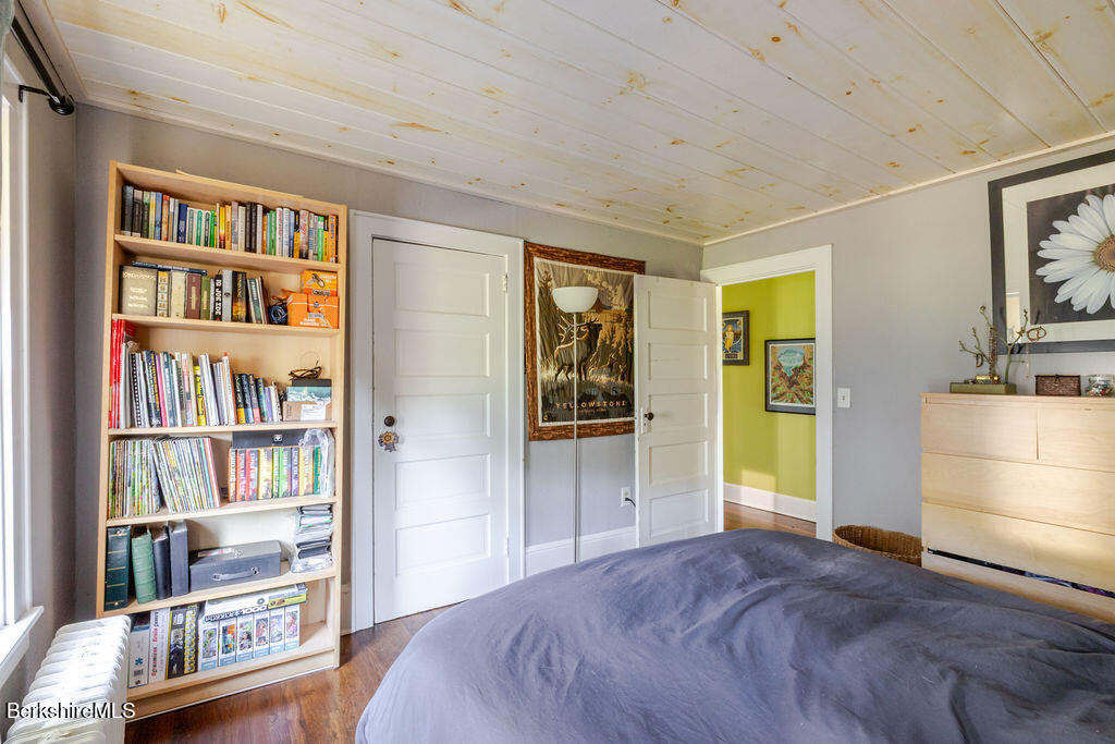6 Locust Street Great Barrington, MA 01230 - Photo 24 of 36 a bed room with a bed and a book shelf