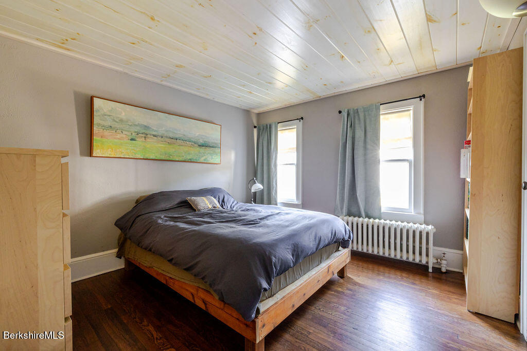 6 Locust Street Great Barrington, MA 01230 - Photo 25 of 36 a bedroom with a bed and wooden floor