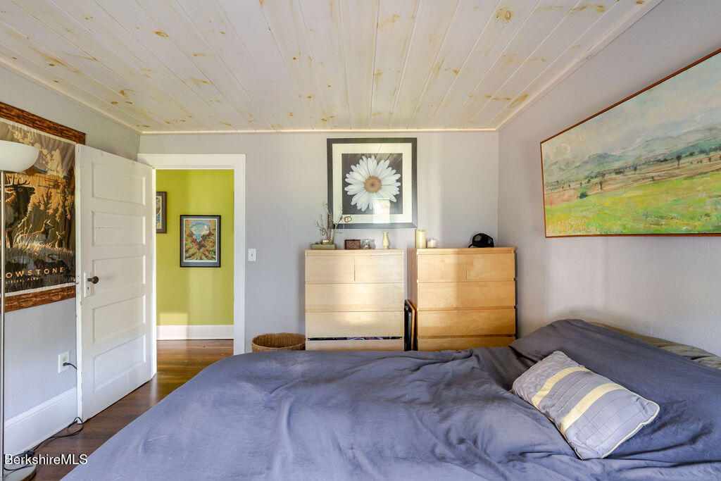 6 Locust Street Great Barrington, MA 01230 - Photo 26 of 36 a bedroom with a bed and wooden floor