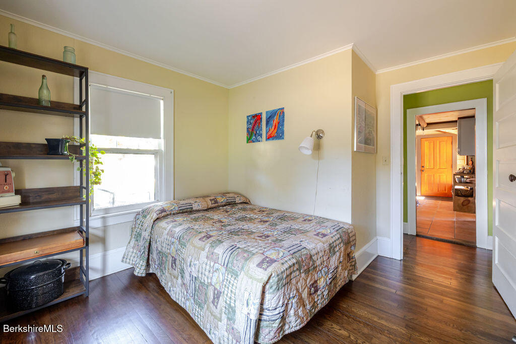 6 Locust Street Great Barrington, MA 01230 - Photo 27 of 36 a bedroom with a bed and wooden floor