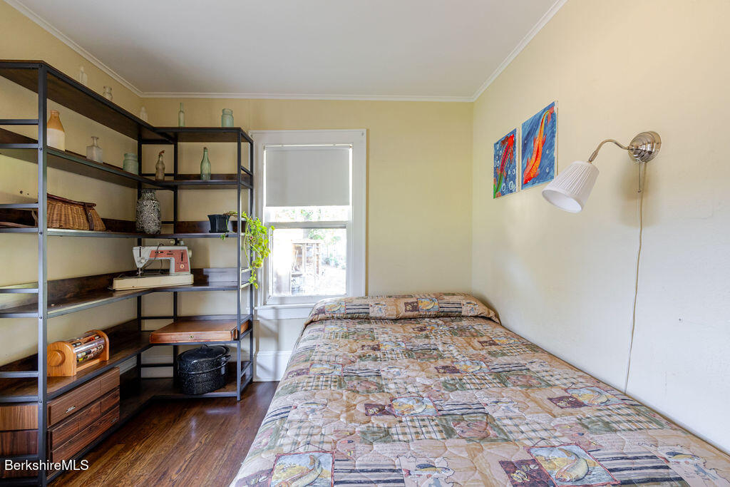 6 Locust Street Great Barrington, MA 01230 - Photo 28 of 36 a bedroom with furniture and a book shelf