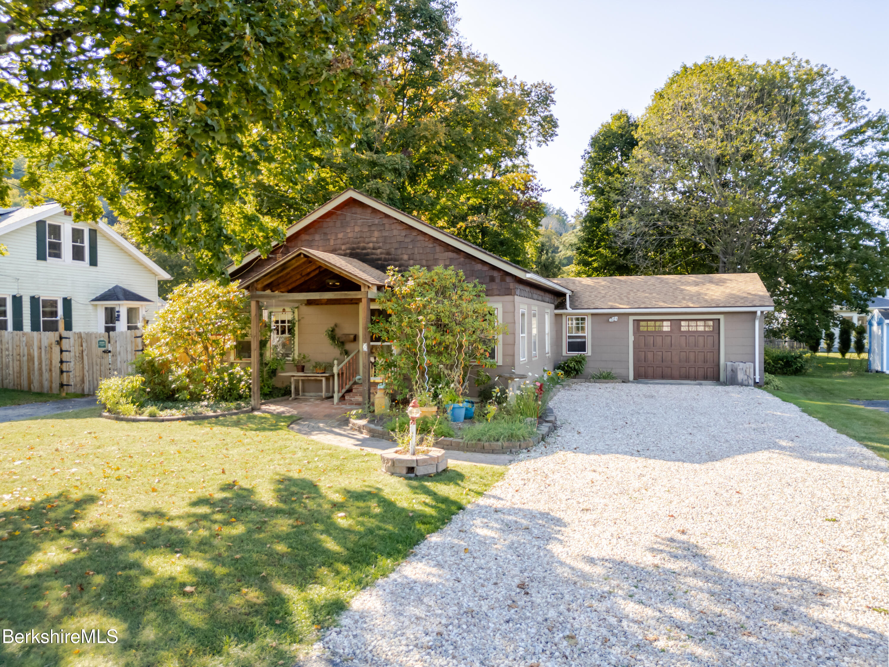 6 Locust Street Great Barrington, MA 01230 - Photo 4 of 36 a front view of a house with a yard and garage