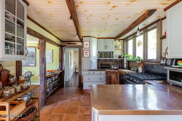 a kitchen with stainless steel appliances granite countertop a stove and cabinets