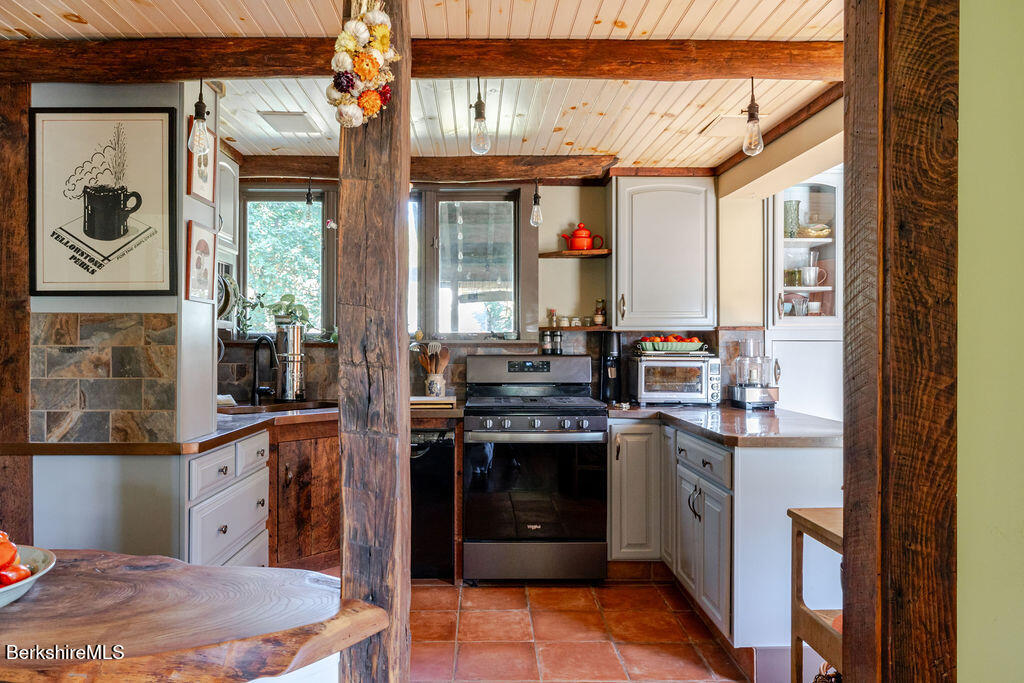 6 Locust Street Great Barrington, MA 01230 - Photo 10 of 36 a kitchen with stainless steel appliances granite countertop a stove a sink and a refrigerator