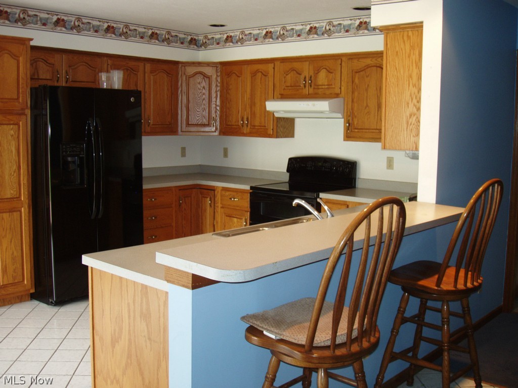 13132 Whitney Road Strongsville, OH 44136 - Photo 7 of 21 Breakfast bar plus a large eating area to the left of the photo