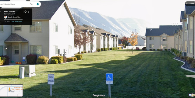 2525 West 450 South, Unit 8 Springville, UT 84663 - Photo 21 of 22 Residential buildings featuring light-colored siding and dark shingle roofs, with a prominent green lawn